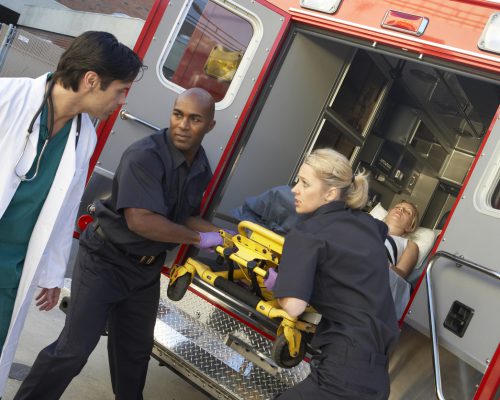Paramedics unloading patient from ambulance